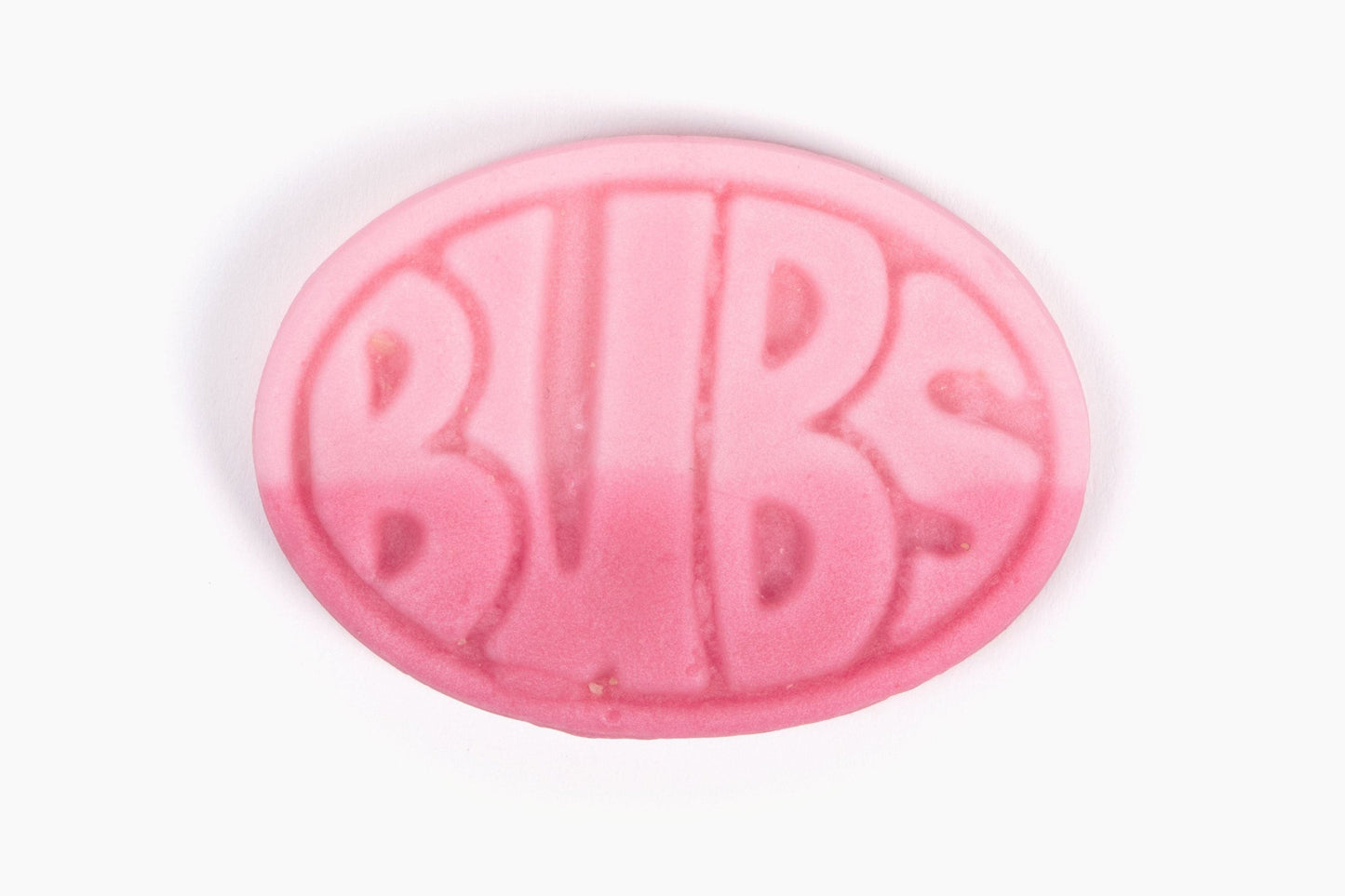 Swedish Candy Club pink oval pomegranate and wild strawberry candy with BUBS logo embossed, sour foam texture.