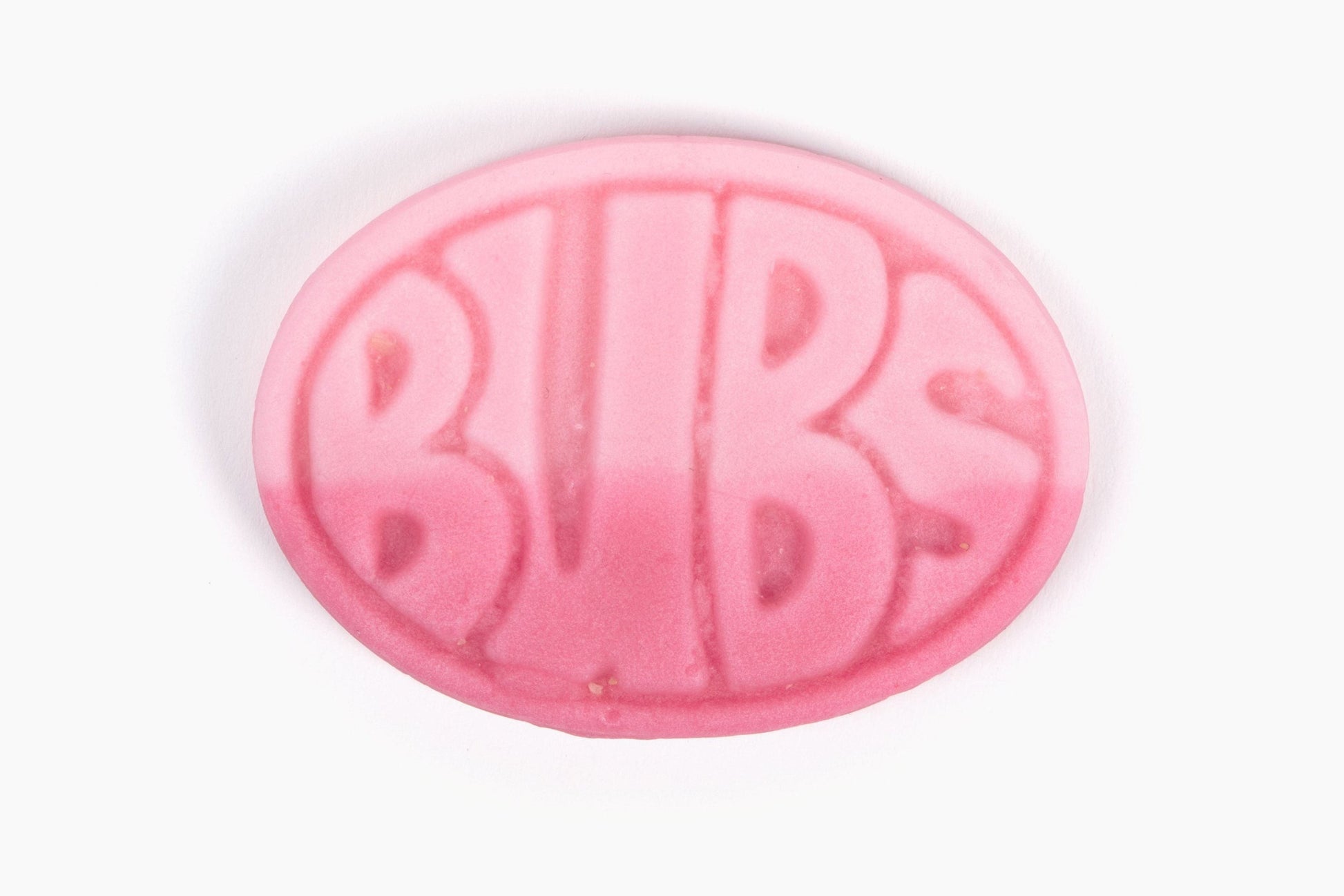 Swedish Candy Club pink oval pomegranate and wild strawberry candy with BUBS logo embossed, sour foam texture.