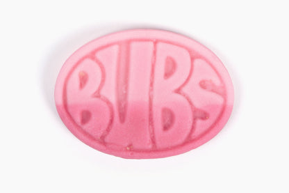 Swedish Candy Club pink oval pomegranate and wild strawberry candy with BUBS logo embossed, sour foam texture.