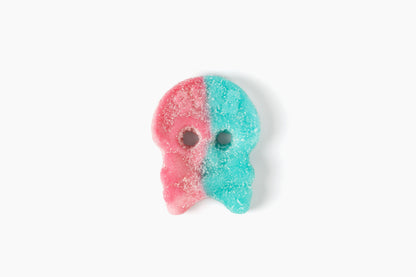 Swedish Candy Club Swede & Sour gummy skull candy, Dizzy Skulla, half pink, half turquoise, coated in sugar.