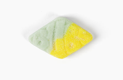 Swedish Candy Club diamond-shaped gummy candy, half green and half yellow, dusted with sugar.
